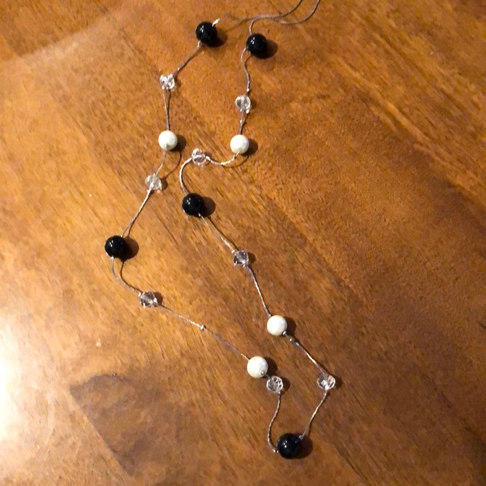 Long necklace with black, clear stones and pearls.